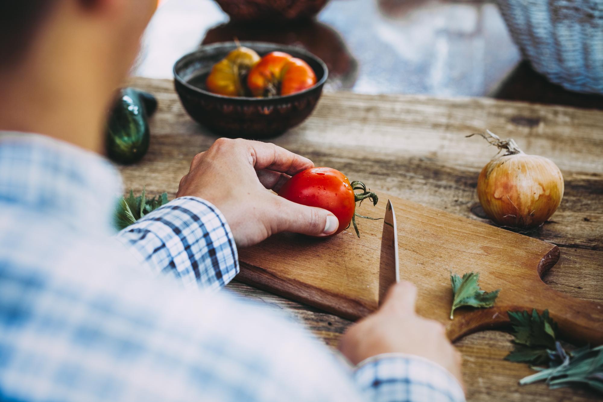 Chef arranging local produce on wooden board